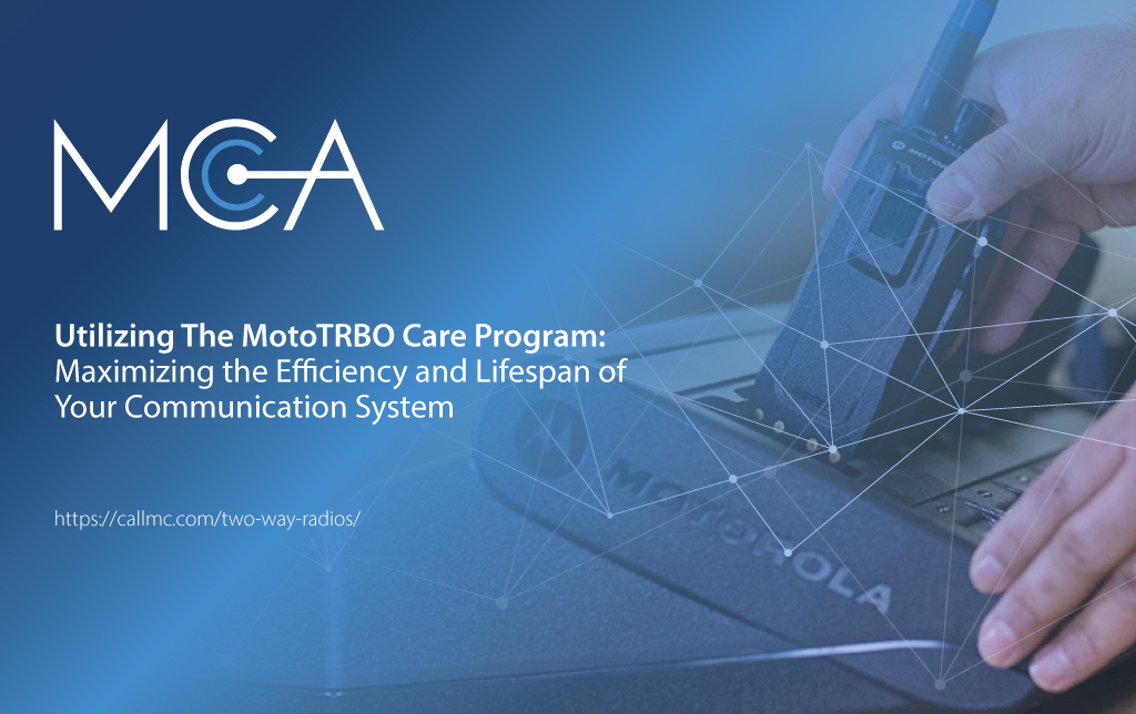 a person putting a two-way radio back on a charger utilizing the MotoTRBO Care, which is a comprehensive lifecycle management solution that simplifies system upkeep, enhances performance, and offers predictable costs.