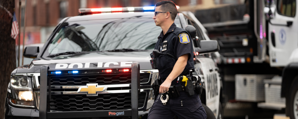 Police Officer Wearing an APX 4000 Radio Clipped to His Belt While Walking