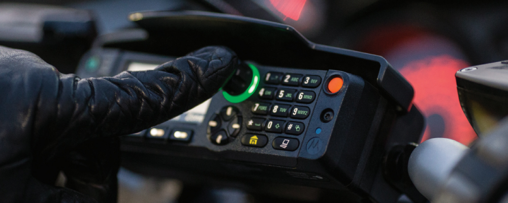 Officer Pushing Buttons on APX 6500 Mobile Two Way Radio