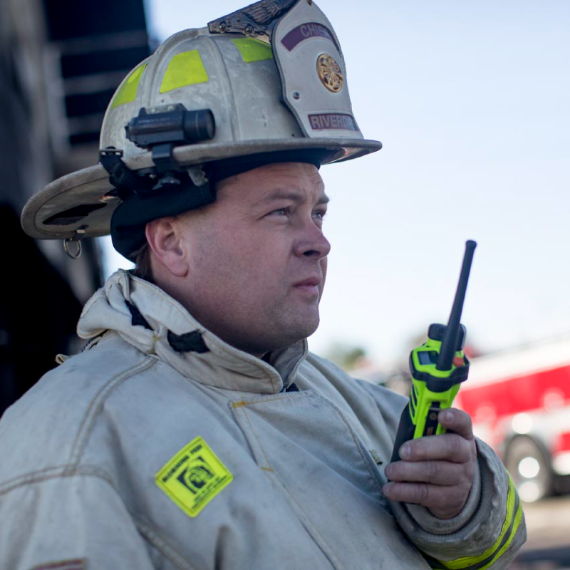 Motorola APX 6000XE Two Way Radio in Firefighters Hand