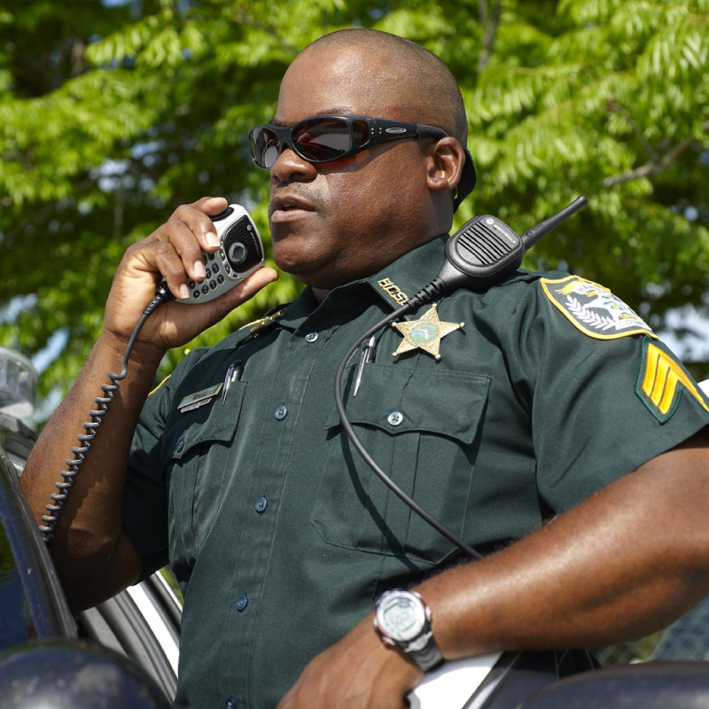 Officer Talking on APX 6500 Mobile Two Way Radio with Hand Mic