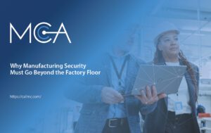 manufacturing floor managers - with an open laptop - discussing security measures