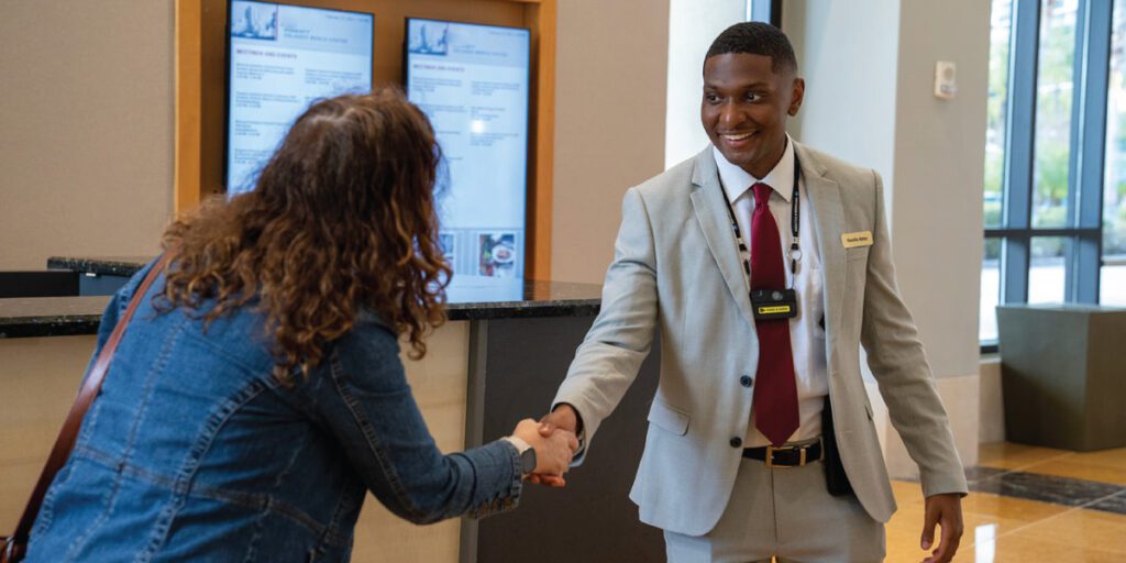 Hotel Staff Using a VT100 Body Camera at Concierge Desk